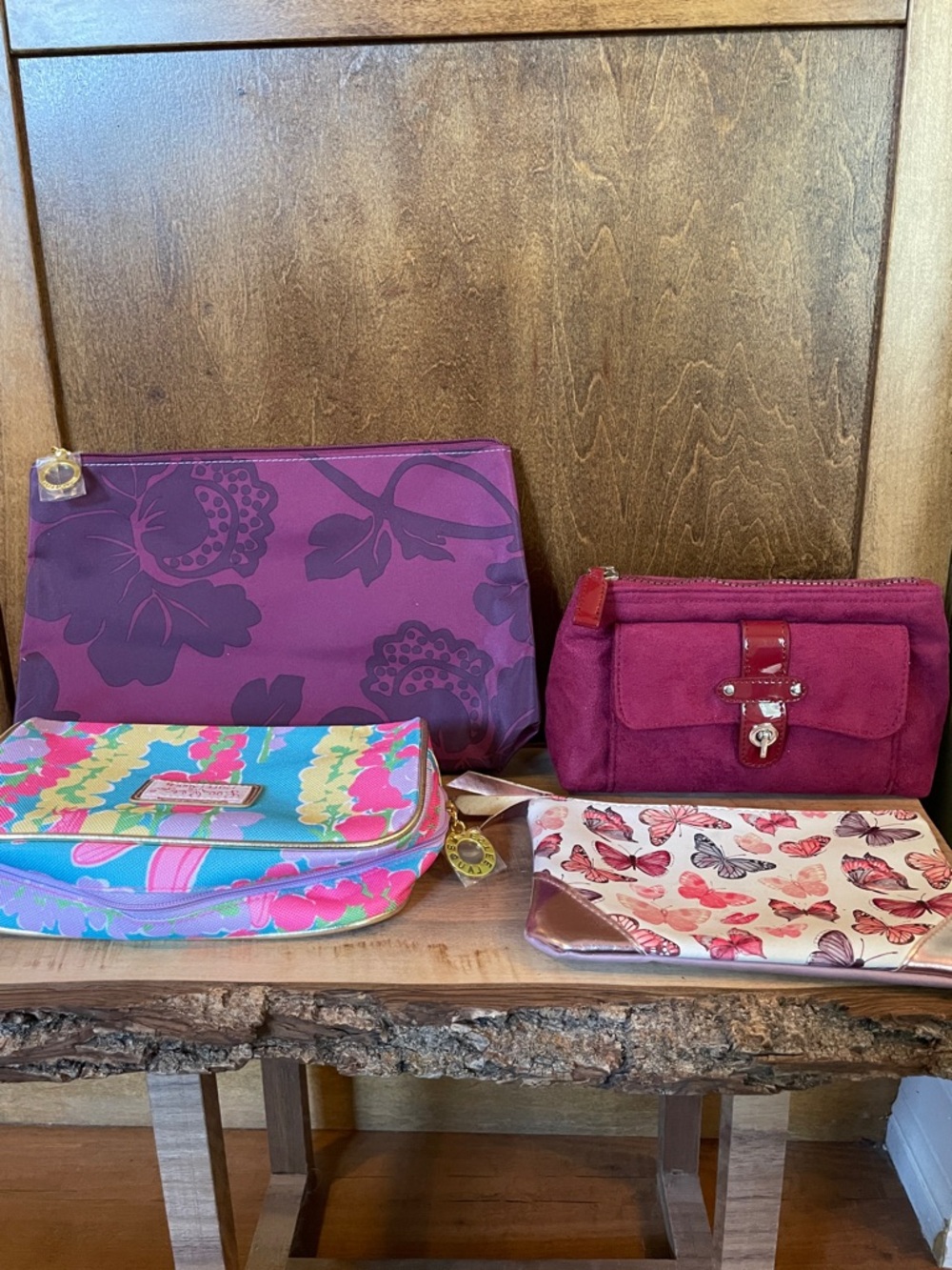 Set of purple hued cosmetic bags.